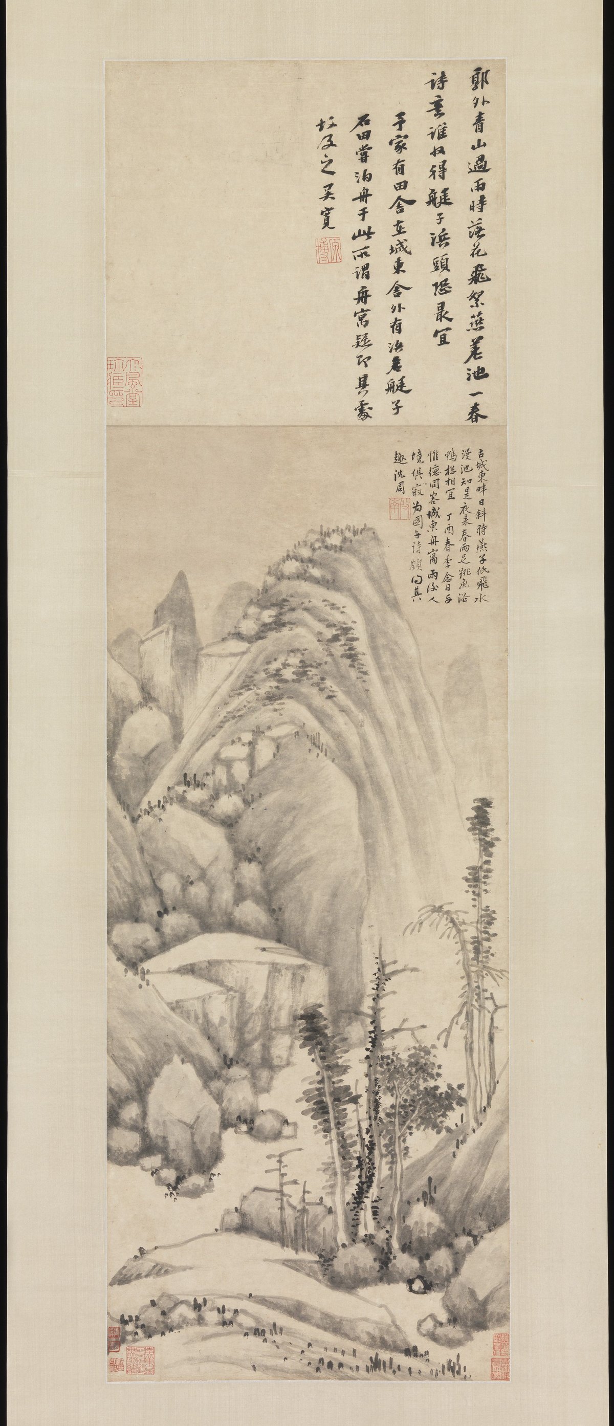 A tall ink landscape with mountains, trees and water; inscriptions occupy the upper area, with red seals among the writing and landscape.